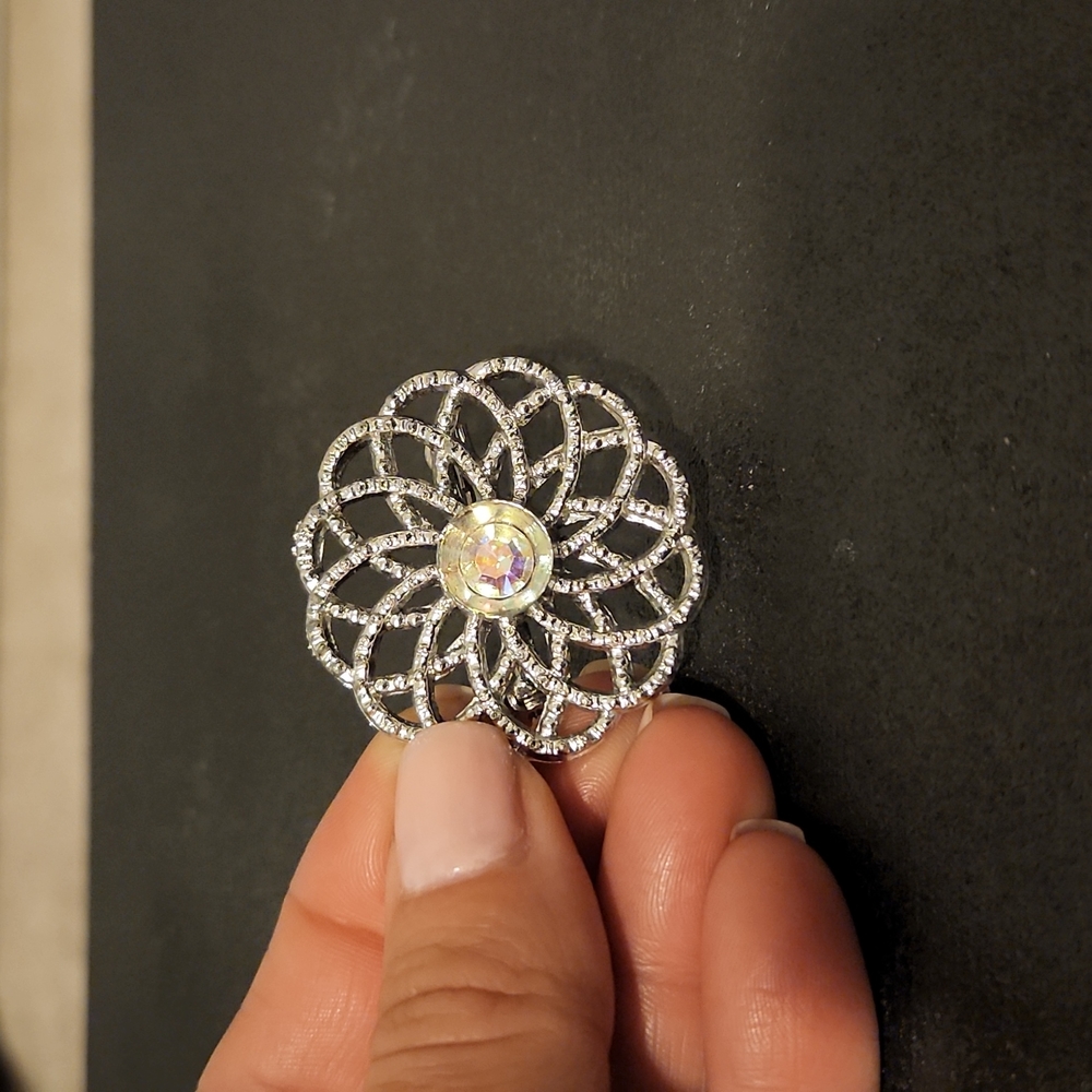 Silver brooch with AB crystal in center